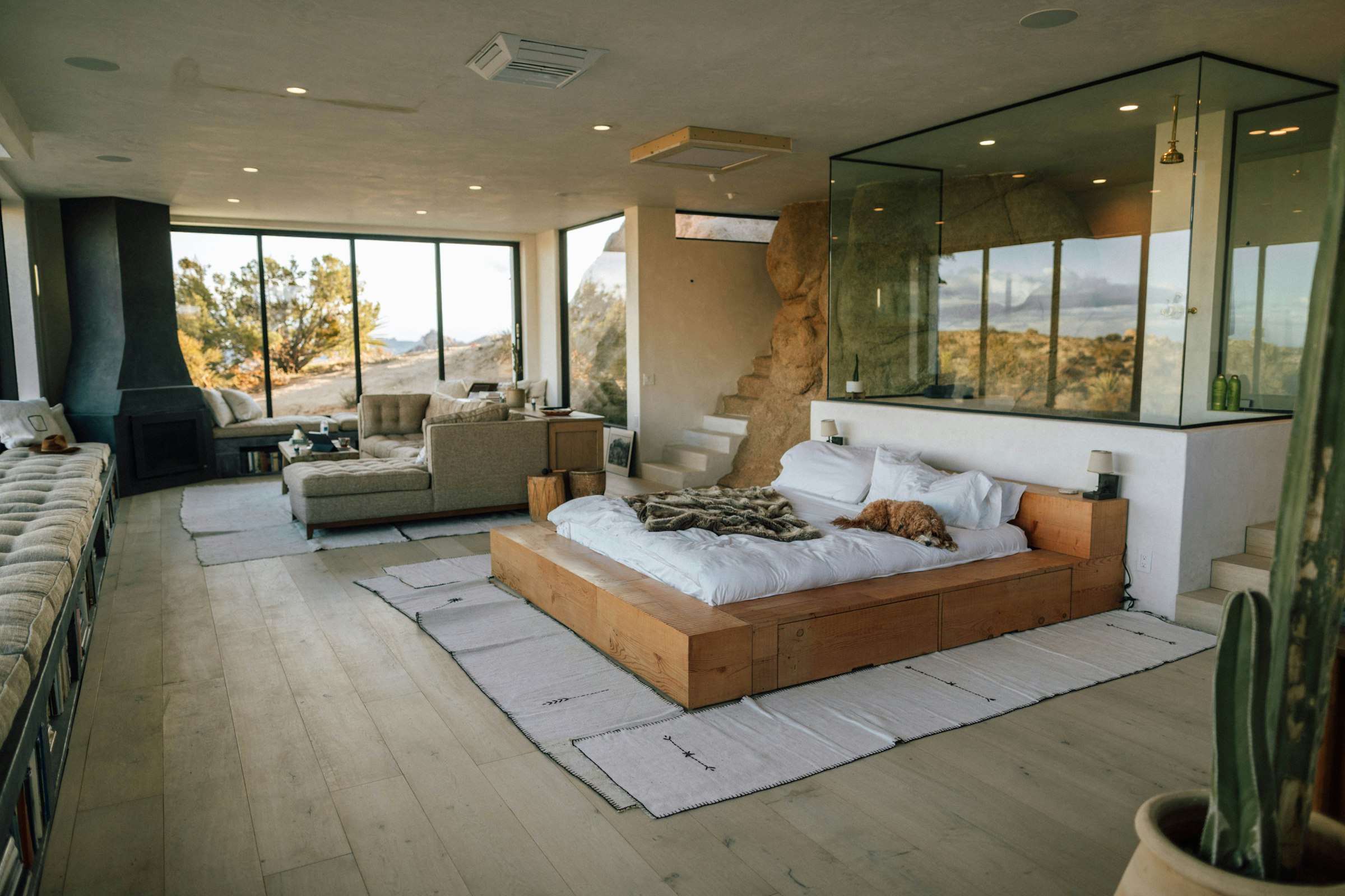 Open living space with floor-to-ceiling glass and a desert view